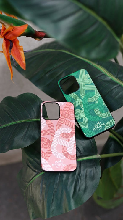 Hermes iPhone 16 Pro Max case with repeating H-pattern in pink, with a black border.